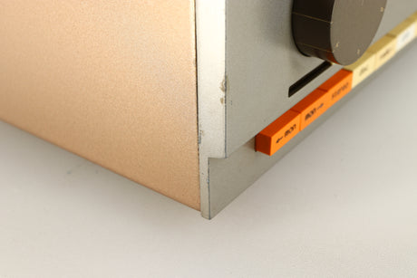 Close up of a used Quad 33 Pre Amplifier showing damage on front left corner