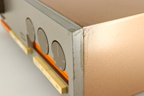 Close up of a used Quad 33 Pre Amplifier showing damage on front right corner