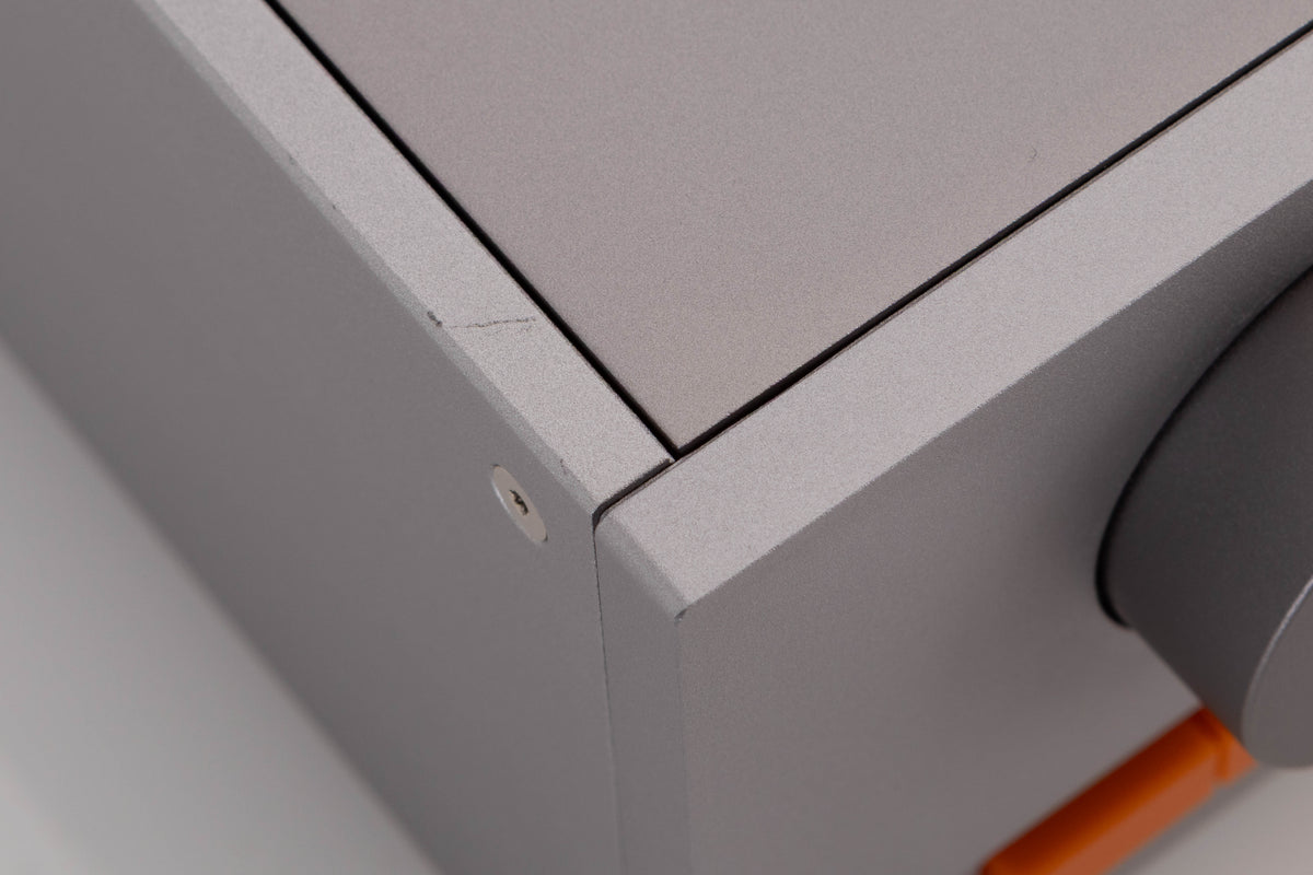 Close up of a used Quad 33 Pre Amplifier in a Silver finish showing light scratch on left side edge