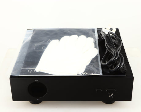Top of a used Quad Artera Pre Amplifier in a black finish showing Mains Cable, 2x Gloves and Manual