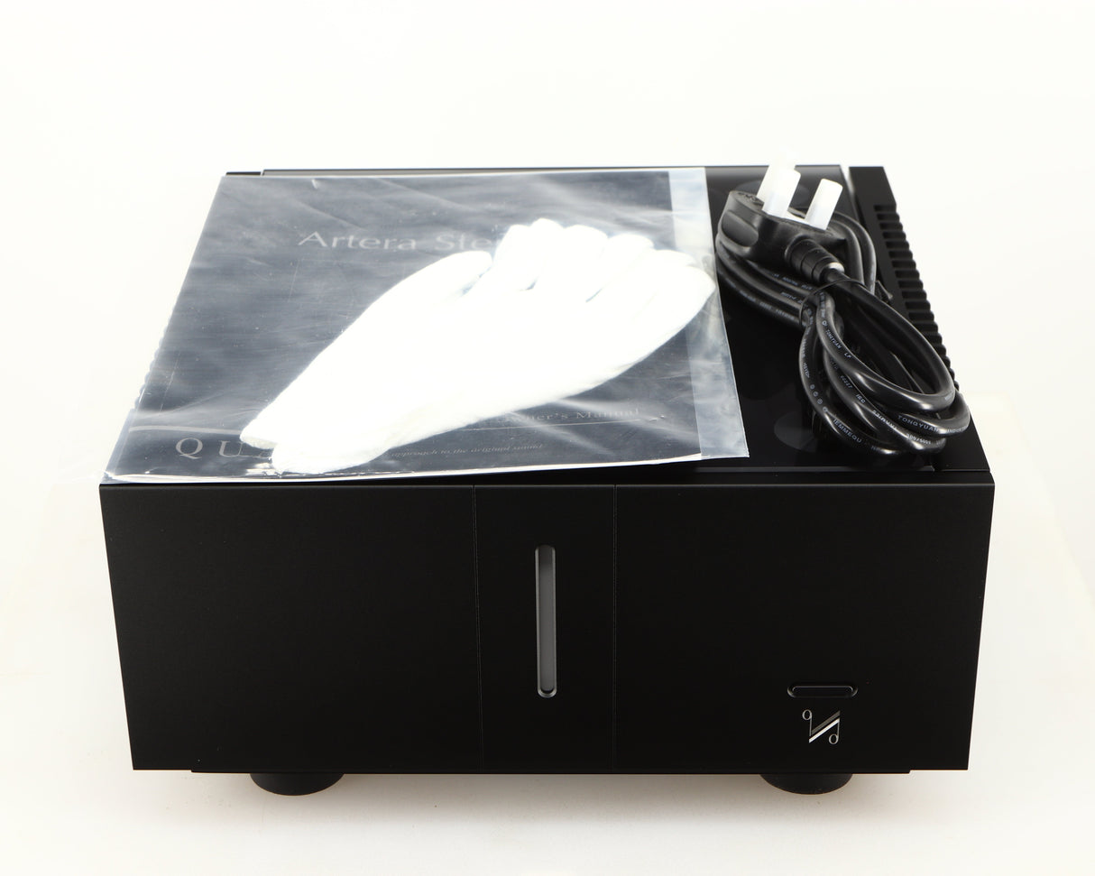 Top of a used Quad Artera Stereo Power Amplifier in a black finish showing Manual, 2x Gloves and Mains Cable