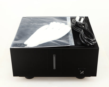 Top of a used Quad Artera Stereo Power Amplifier in a black finish showing Manual, 2x Gloves and Mains Cable