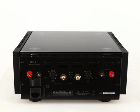Rear view of a used Quad Artera Stereo Power Amplifier in a black finish showing Speaker Ouputs, Mains Input, Line Inputs and XLR Inputs