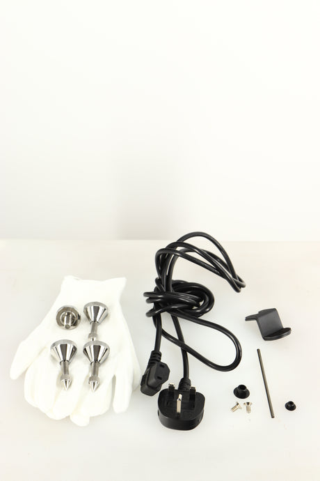 Accessories for a used Quad ESL-2812 Floorstanding Speaker in a black finish showing 4x Feet, Allen Key, 2x Screws, 2x Gloves, 2x Brackets and Mains Cable