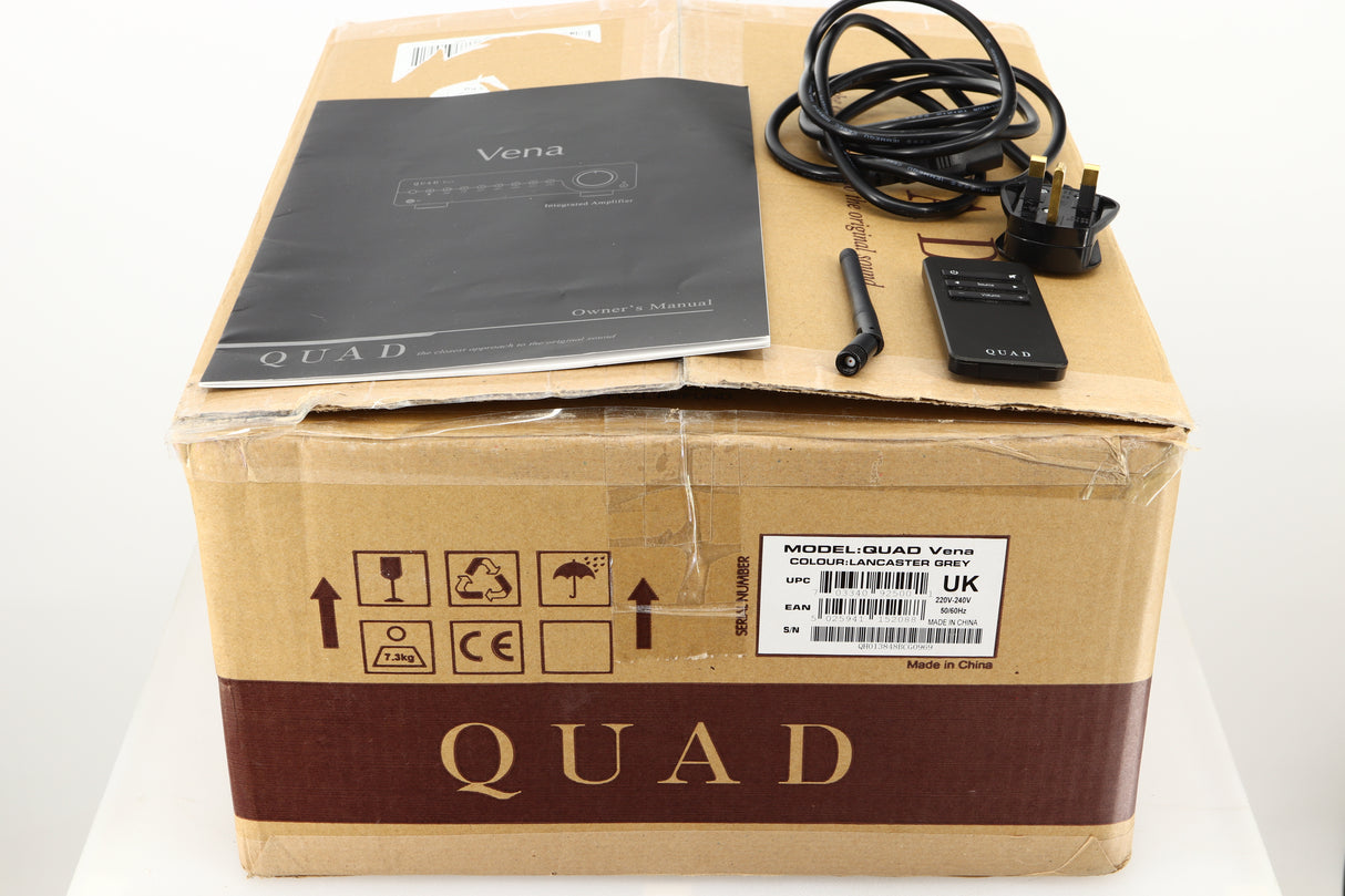Box of a used Quad Vena Integrated Amplifier in Lancaster Grey finish showing mains cable, manual, remote, and antenna