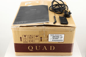 Box of a used Quad Vena Integrated Amplifier in Lancaster Grey finish showing mains cable, manual, remote, and antenna