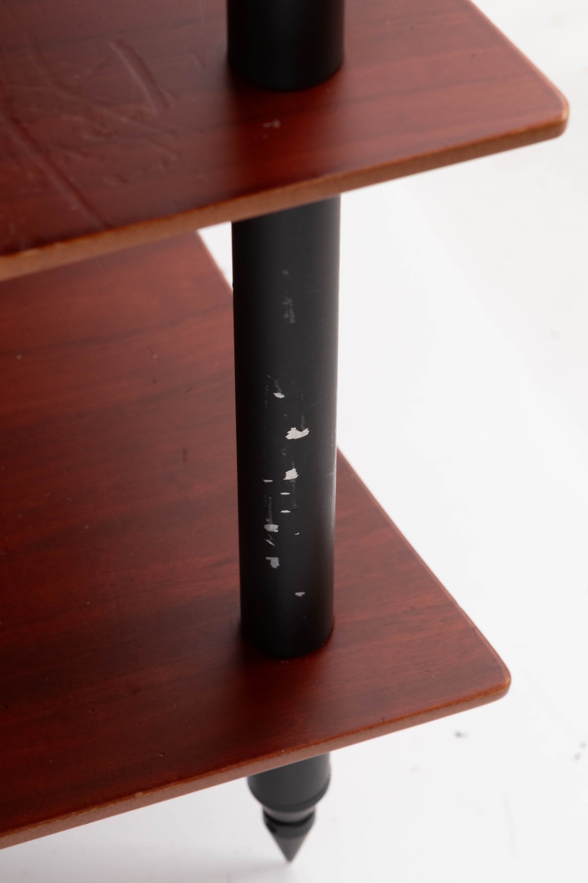 Close up of a used Quadraspire 4 Shelf Hifi Stand in a Dark Cherry / Black finish showing damage on stand