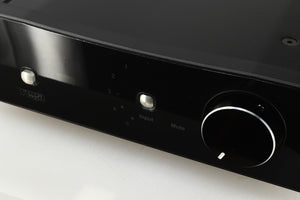 Close up of a used Rega Brio-R Integrated Amplifier in a black finish showing light scratching on screen