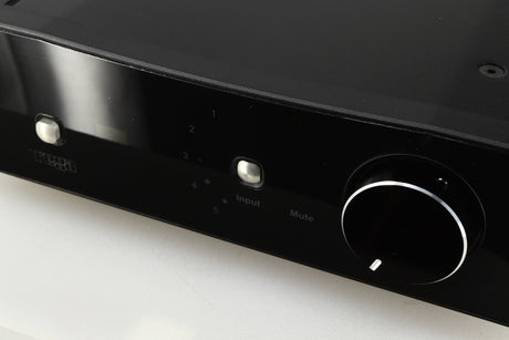 Close up of a used Rega Brio-R Integrated Amplifier in a black finish showing light scratching on screen