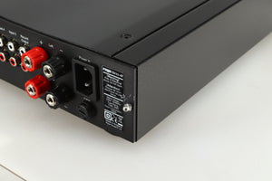 Rear left corner of a used Rega Brio-R Integrated Amplifier in a black finish