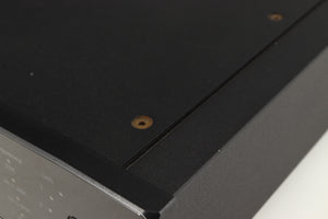 Close up of a used Rega DAC Digital Analogue Converter in a black finish showing small nick on right side edge