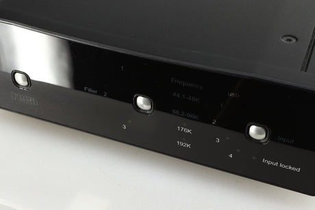 Close up of a used Rega DAC-R Digital Analogue Converter in a black finish showing scratching on the screen
