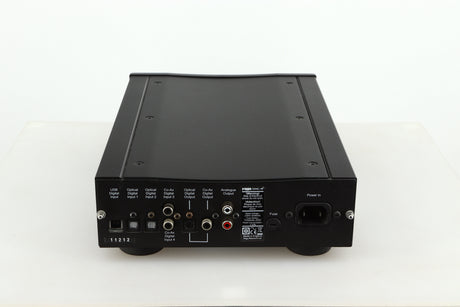 Rear view of a used Rega DAC-R Digital Analogue Converter in a black finish showing Analogue Outputs, Mains Input, Optical Digital Outputs and Inputs and USB Digital Input