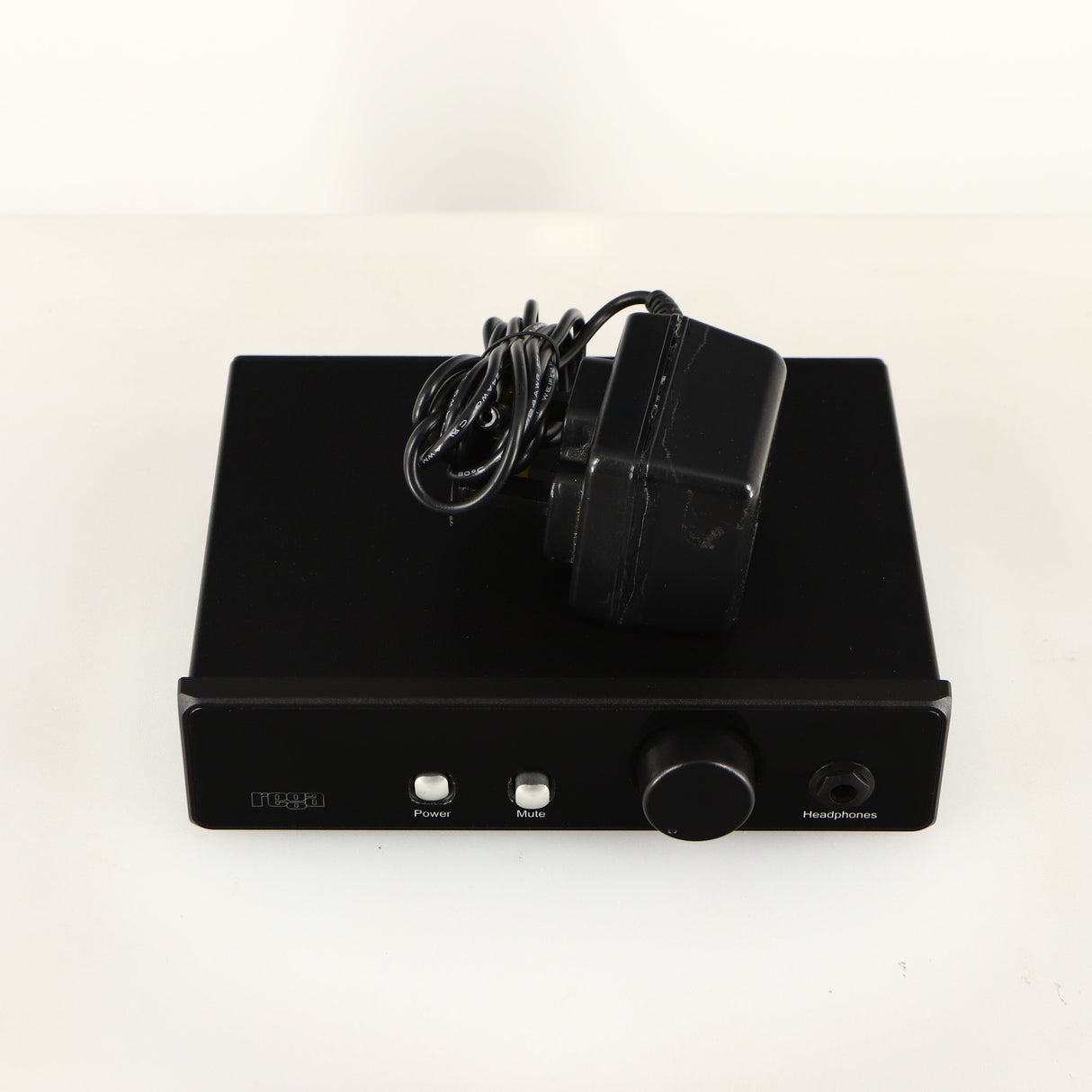 Top of a used Rega EAR Headphone Amplifier in a black finish showing PSU