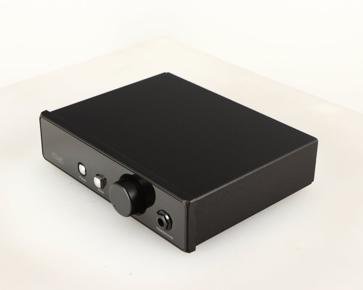 Front right corner of a used Rega EAR Headphone Amplifier in a black finish