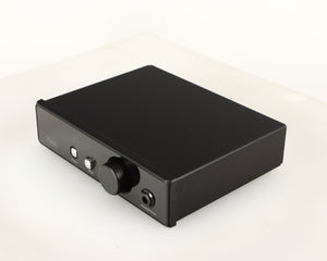 Front right corner of a used Rega EAR Headphone Amplifier in a black finish