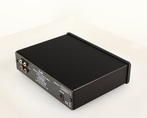 Rear left corner of a used Rega EAR Headphone Amplifier in a black finish