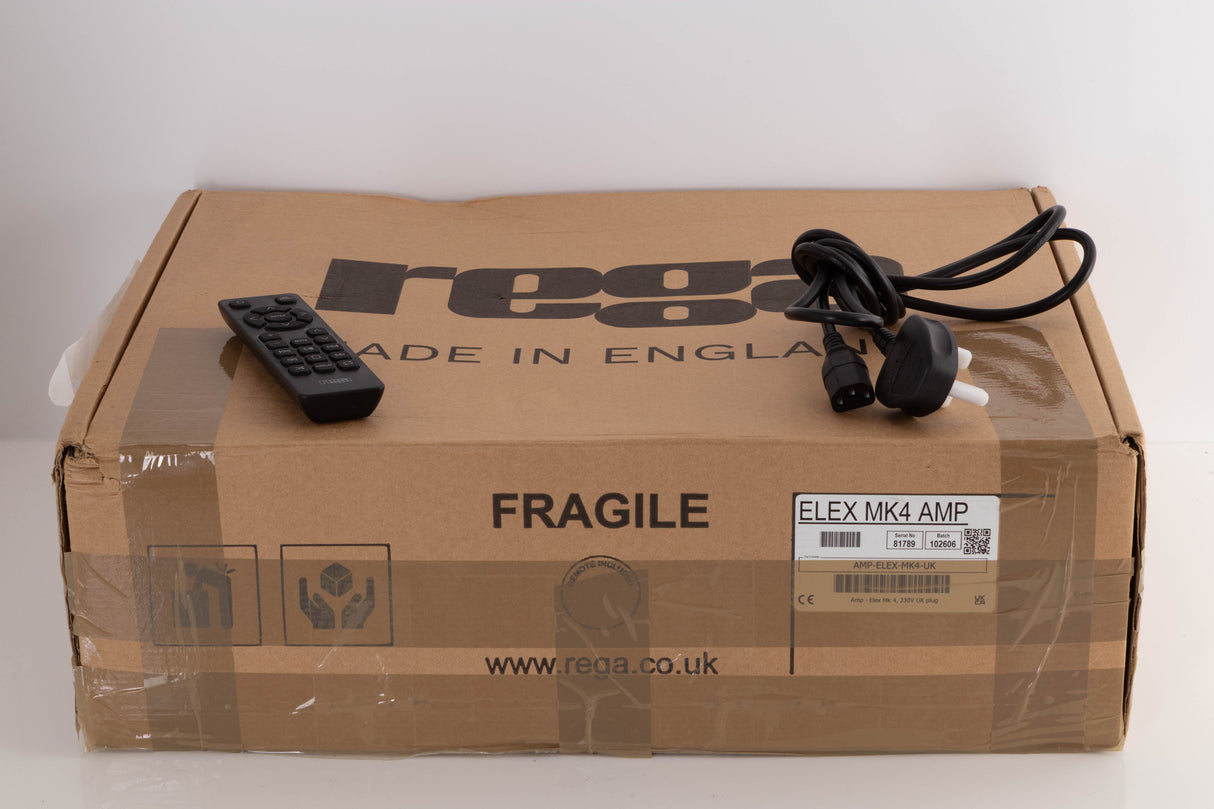 Box for a used Rega Elex MK4 Integrated Amplifier in a Black finish showing scratches on screen showing Remote and Mains Cable