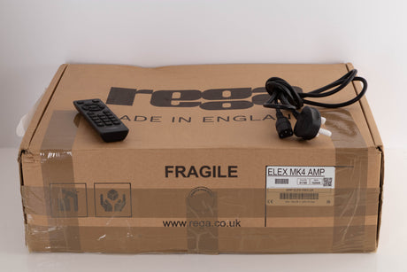 Box for a used Rega Elex MK4 Integrated Amplifier in a Black finish showing scratches on screen showing Remote and Mains Cable