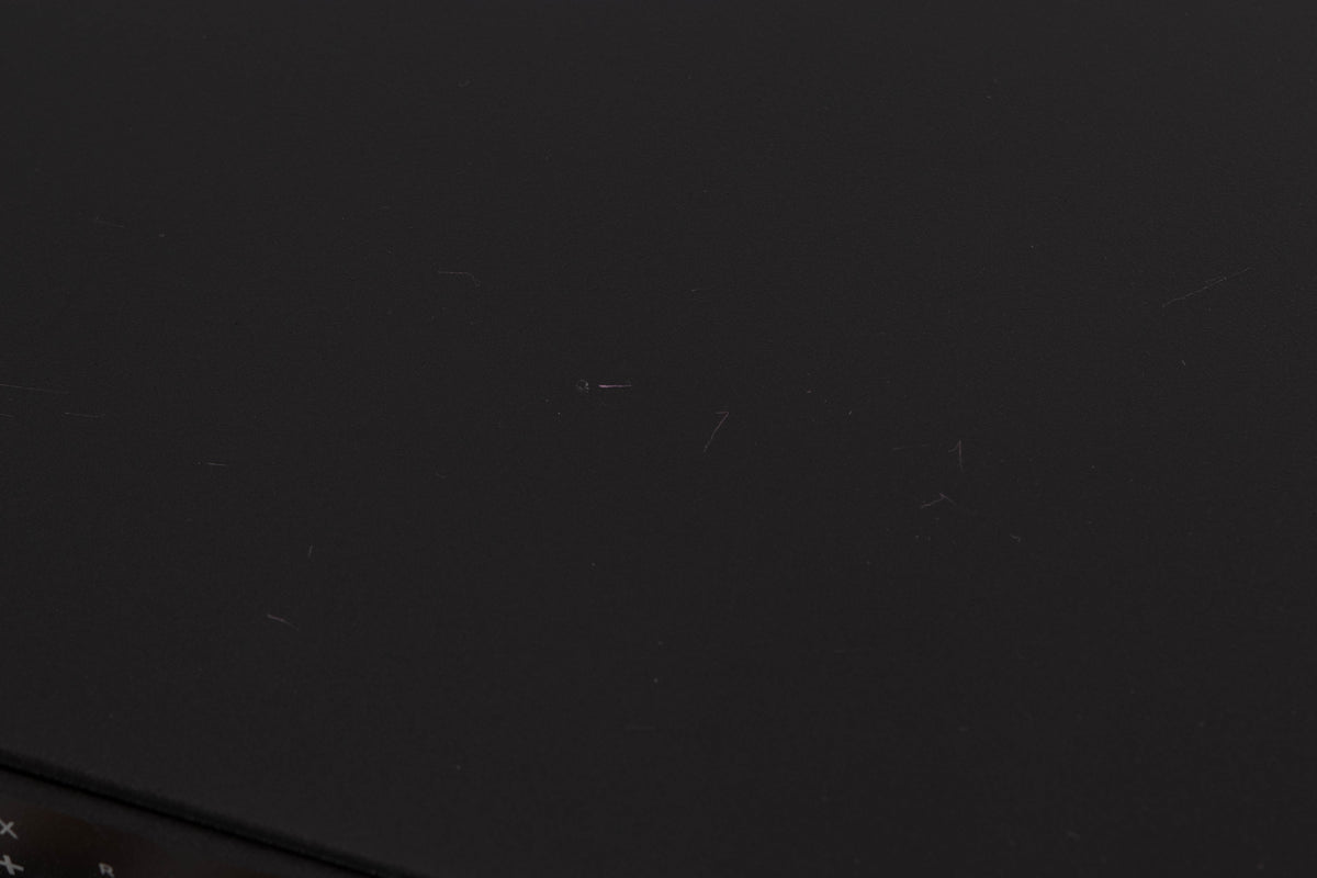 Close up of a used Rega Elex MK4 Integrated Amplifier in a Black finish showing scratches on top