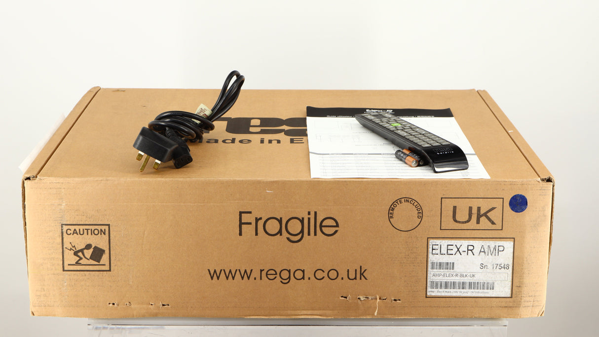 Box for a used Rega Elex-R Integrated Amplifier in a black finish showing Mains Cable, Manual, Remote and 2x Batteries