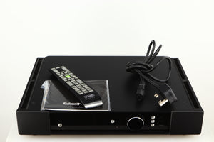Top of a used Rega Elicit-R Integrated Amplifier in a black finish showing Remote, Mains Cable and Manual