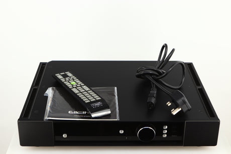 Top of a used Rega Elicit-R Integrated Amplifier in a black finish showing Remote, Mains Cable and Manual