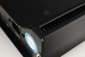 Close up of a used Rega Elicit-R Integrated Amplifier in a black finish showing small chip on rear left corner 