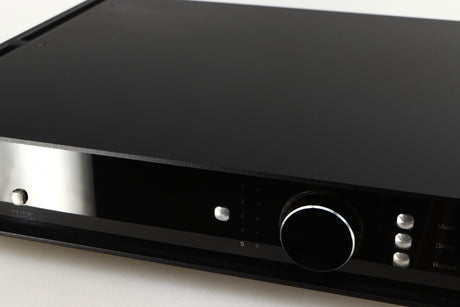 Close up of a used Rega Elicit-R Integrated Amplifier in a black finish showing some scratching on screen 