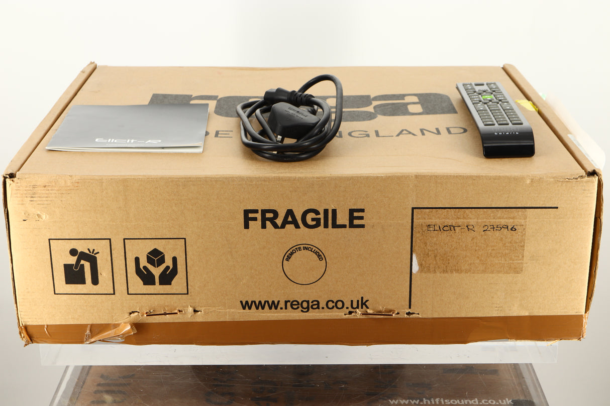 Box of a used Rega Elicit-R Integrated Amplifier with mains cable, manual, and remote 