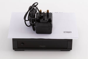 Top of a used Rega FONO MC MK4 Phonostage in a Black finish showing PSU and Manual