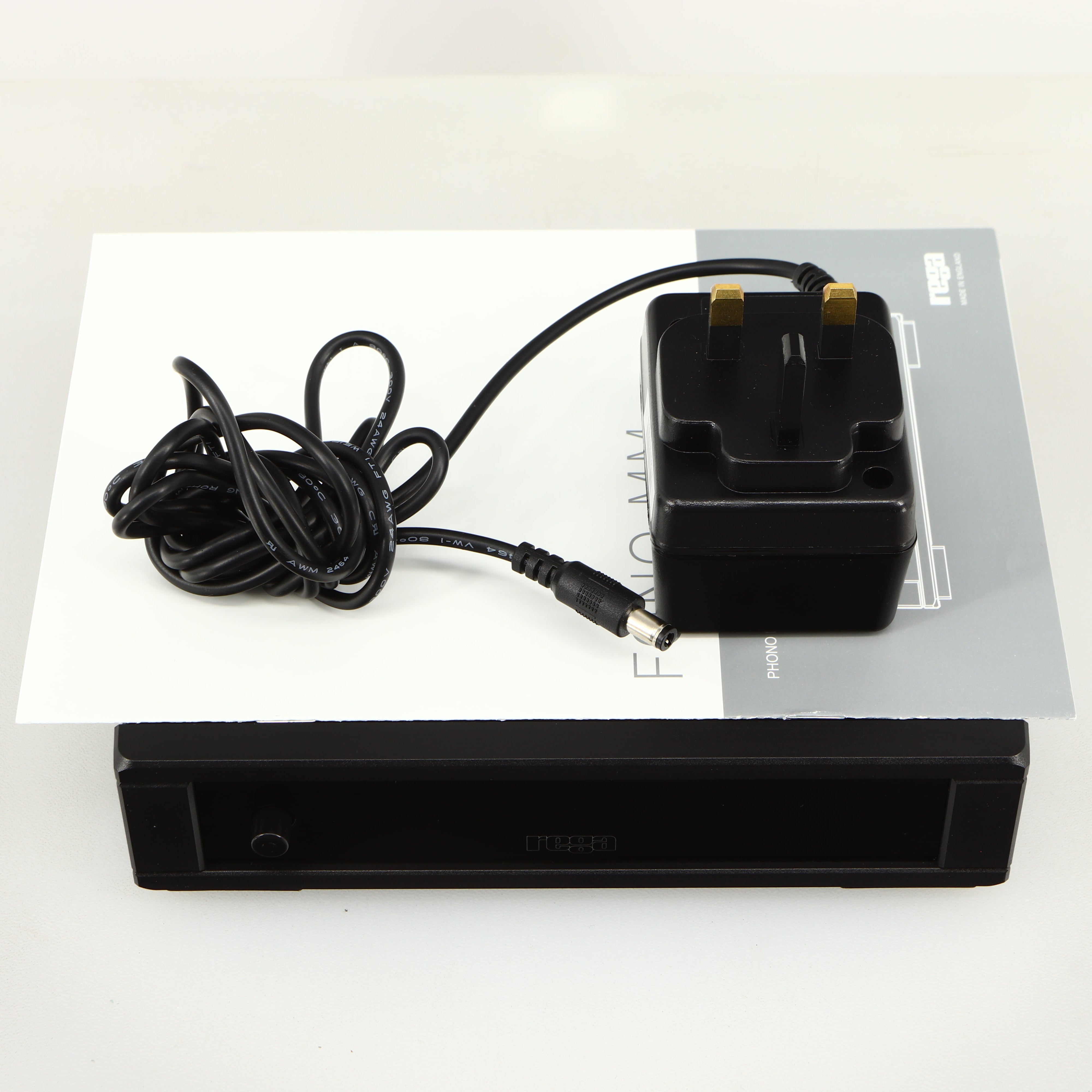 Top of a used Rega FONO MM MK5 Phonostage in a black finish showing Manual and PSU