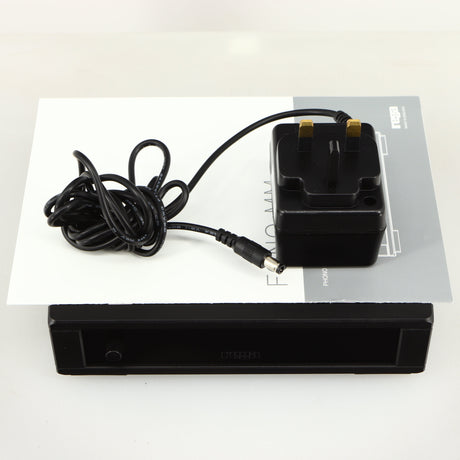 Top of a used Rega FONO MM MK5 Phonostage in a black finish showing Manual and PSU