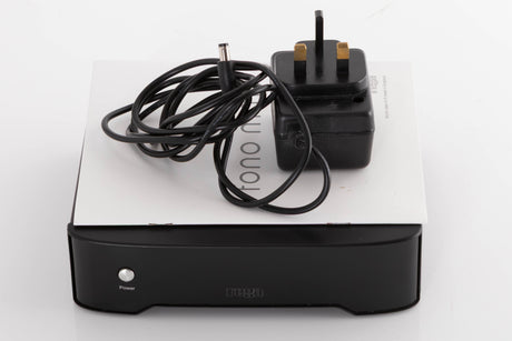 Top of a used Rega FONO MM Phonostage in a Black finish showing Manual and PSU