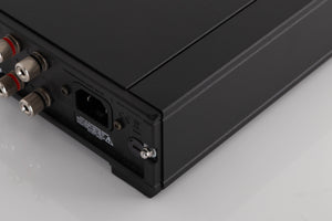 Rear left corner of a used Rega IO Integrated Amplifier in a Black finish