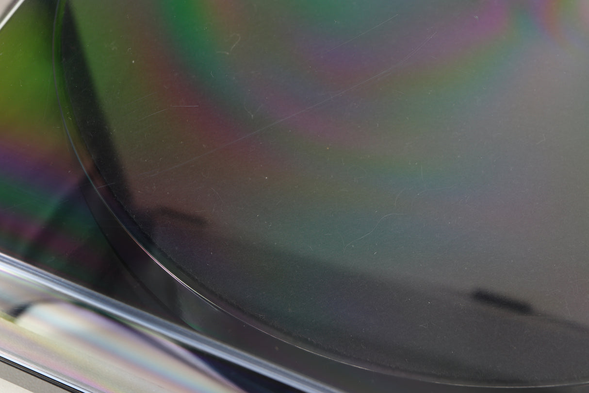 Close up view of a used Rega Planar 1 ECO Turntable in Black Gloss finish showing some scratching on the lid on the top