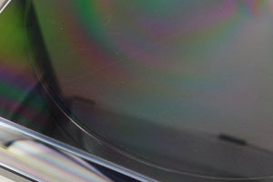Close up view of a used Rega Planar 1 ECO Turntable in Black Gloss finish showing some scratching on the lid on the top