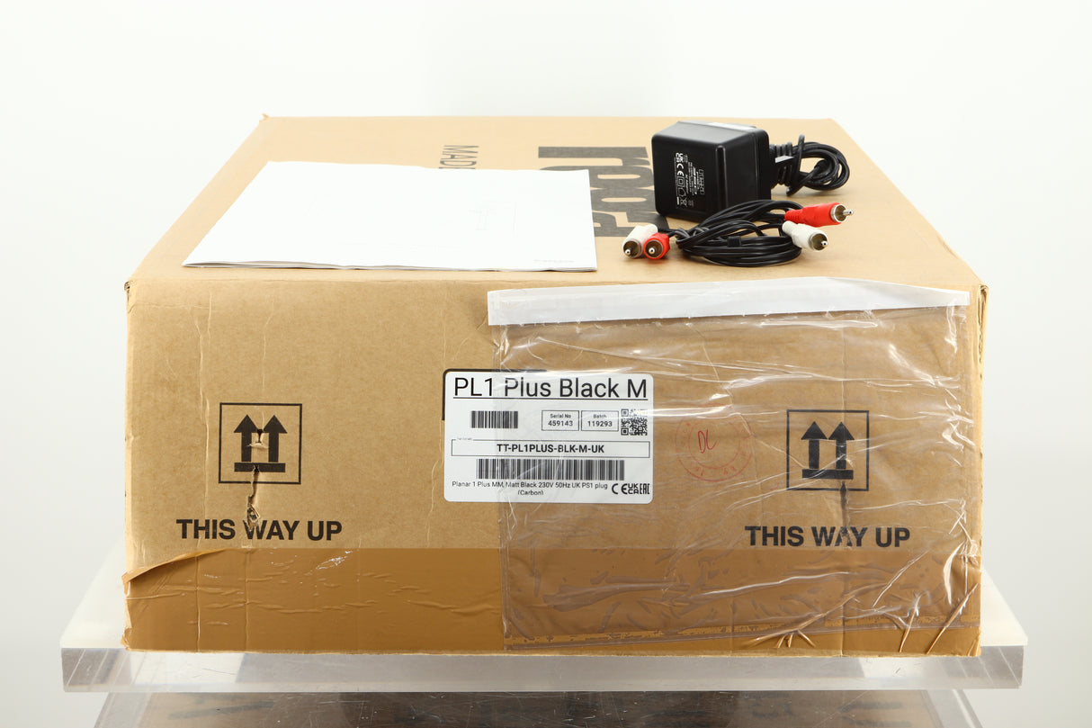 Box of a used Rega Planar 1 Plus Turntable in Matt Black showing mains cable, manual, and phono cables