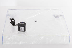 Accessories for a used Rega Planar 1 Turntable in a White finish showing Lid and PSU