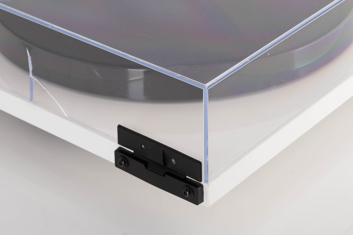 Rear left corner of a used Rega Planar 1 Turntable in a White finish