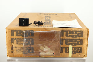 Box of a used Rega Planar 2 Turntable / 24V Upgraded / Exact Cartridge showing a power supply, manual and cartridge alignment protractor 
