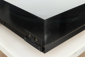 Rear left corner of a used Rega Planar 2 Turntable / 24V Upgraded / Exact Cartridge in a black finish 