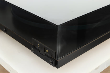 Rear left corner of a used Rega Planar 2 Turntable / 24V Upgraded / Exact Cartridge in a black finish 
