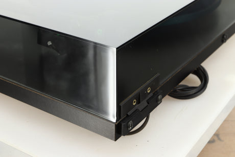 Rear right corner of a used Rega Planar 2 Turntable / 24V Upgraded / Exact Cartridge in a black finish 
