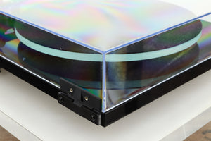 Rear left corner of a used Rega Planar 2 Turntable / AT-VM95E Cartridge in a black finish