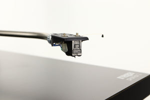 Close up of a used Rega Planar 3 (24V Motor Upgraded) Turntable / Grado F3+ Cartridge in a black finish showing stylus