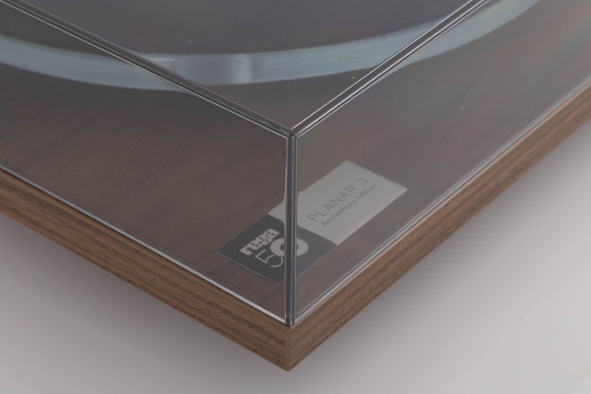 Front left corner of a used Rega Planar 3 50th Anniversary Turntable in a Walnut finish