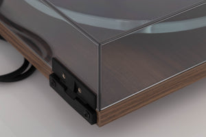 Rear left corner of a used Rega Planar 3 50th Anniversary Turntable in a Walnut finish