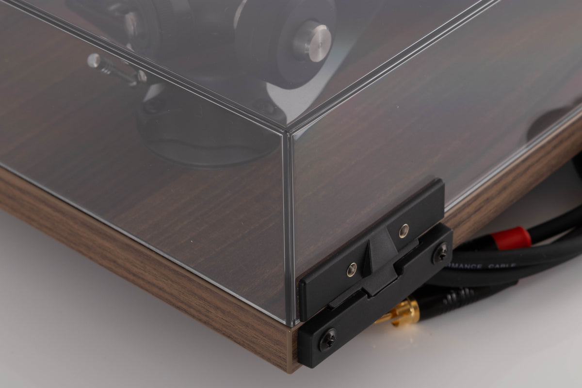 Rear right corner of a used Rega Planar 3 50th Anniversary Turntable in a Walnut finish