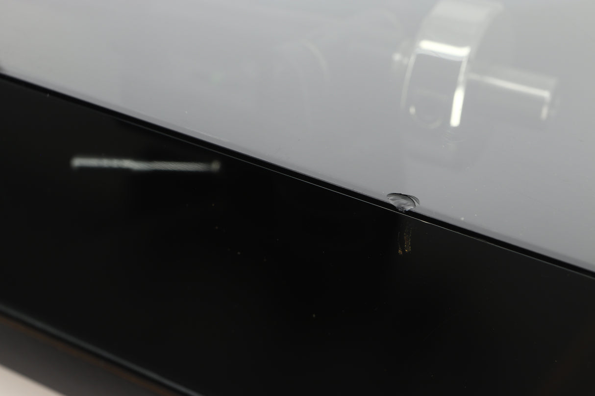 Close up of a used Rega Planar 3 (24V Upgraded) Turntable / Goldring E3 Cartridge in a black finish showing small chip on right side edge of the lid